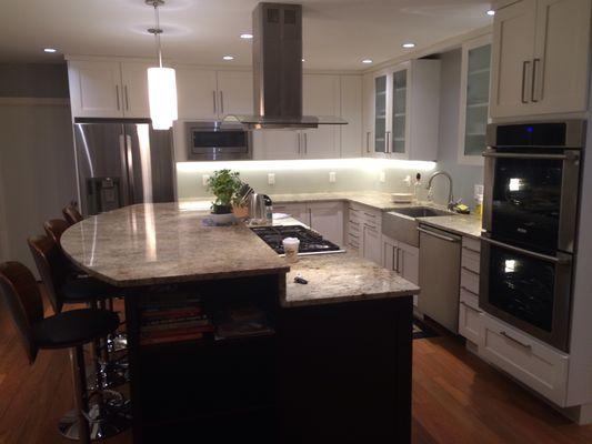 Kitchen featuring white and Ebony cabinetry, granite countertops and stainless steel appliances