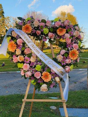 This is the lovely wreath (and stand) that Beautiful Flowers made for us.  (For a personal touch, we opted to make the banner ourselves).