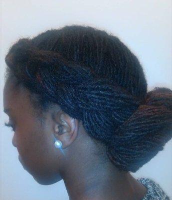 Medium/Large size Sisterlocks in a braided bun style.