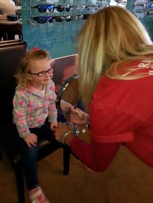 Two year old, Josie, being fitted for eyeglasses by Kami.