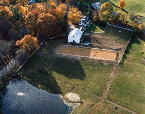 North Road Farm aerial shot of farm, riding arena, pastures and pond.