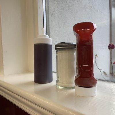 Interior: Condiments on window sill filled and ready for a busy day