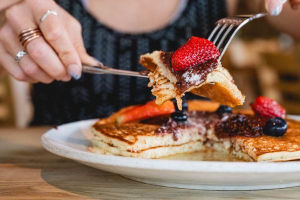 Lemon Ricotta Pancakes with butter and fresh fruit compote