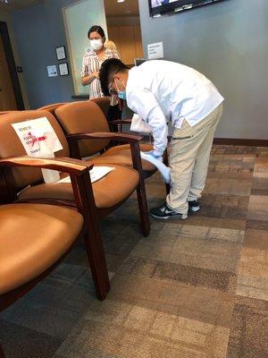 The staff is cleaning the waiting room chairs