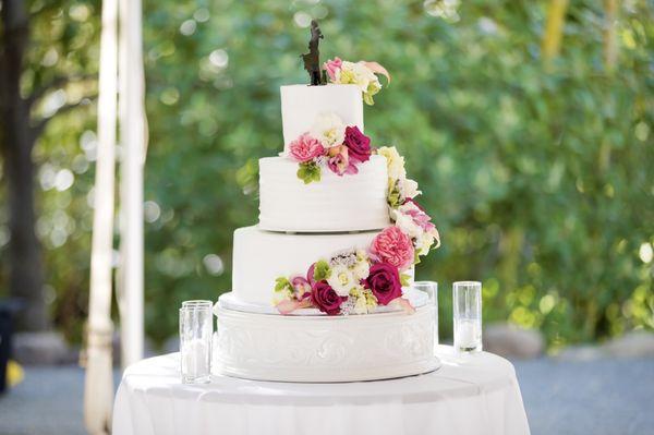 Three-tier wedding cake with strawberry cream, red velvet, and white cream