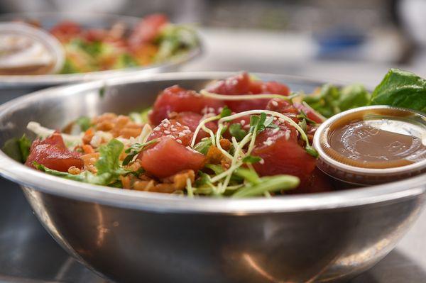 Ahi Tuna Poke;
Sushi-grade tuna, cabbage, mixed greens, bell pepper, daikon sprouts, snow peas, crispy wonton & sesame vinaigrette