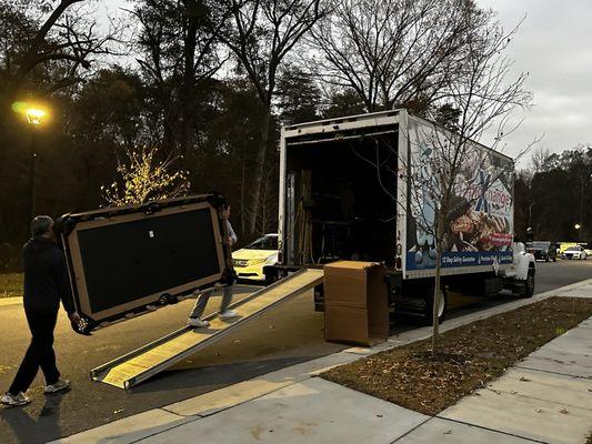 Pool table being loaded onto truck