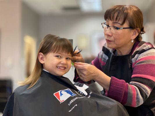 Chelsea giving my kiddo her first haircut