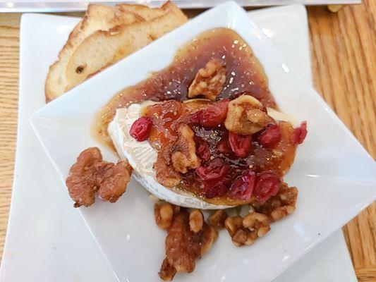 Baked Brie with warm fig jam,  pecans, cranberries, warm crostini