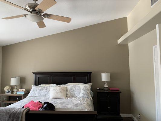 Master bedroom with exclusive ivory and wooden peg accent wall