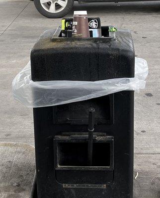 Another overflowing trashcan at the gas pumpS