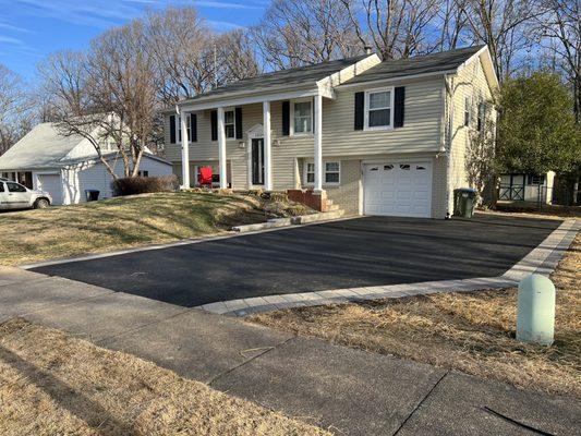 Asphalt driveway with paver border.