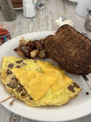 Burnt toast - burnt potatoes and sad looking Omelet