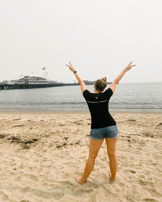 smartboost team member Marina showing off her smartboost shirt at the beach.