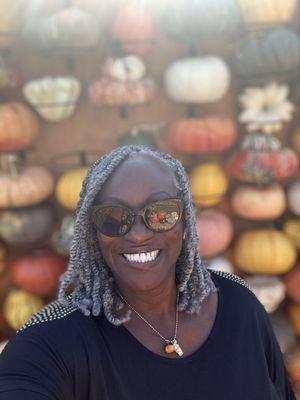 Selfie behind pumpkin wall