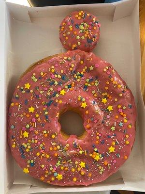 Giant donut cake next to a regular sized donut