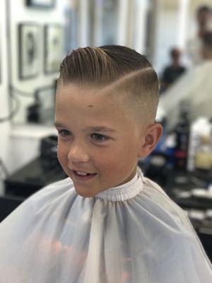 Bald fade with a side part. Styled with Suavecito pomade.