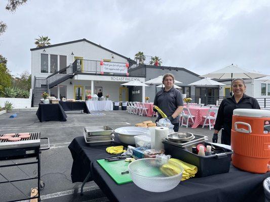 Tables, chairs, umbrellas and linen set up in the background, Making my staff very happy.