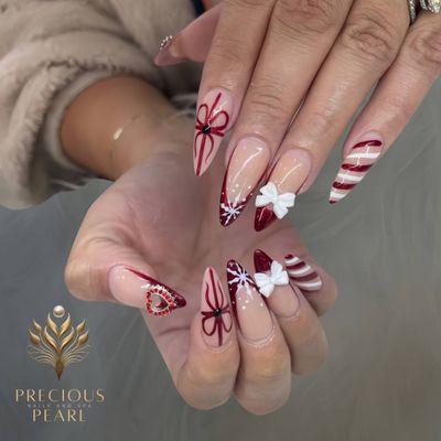 Candy canes, snowflakes, and glittery bows - Christmas nail art has never been this cute! Call us today for a festive manicure.