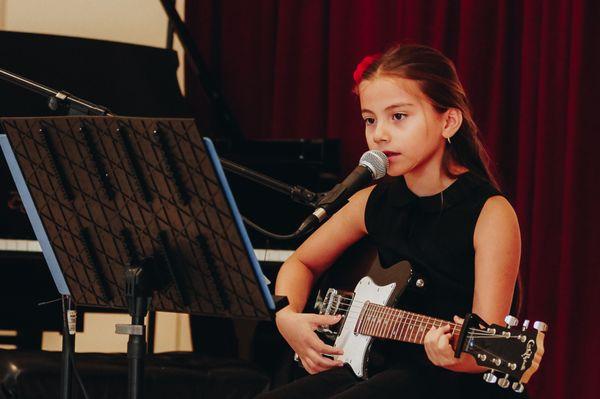 One of our students learning to sing and play electric guitar.