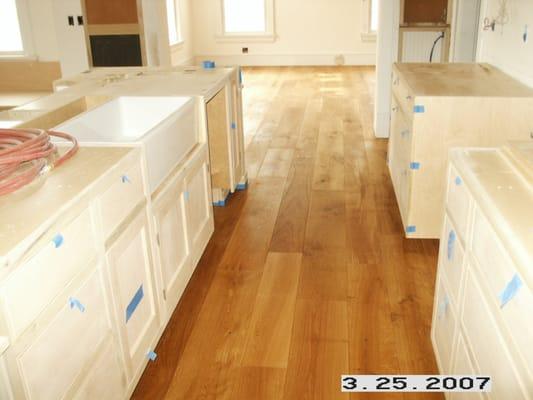 German White Oak Finished with Woca Oil, Not Urethane a plastic coating that shows all the damage of scratching & etching!