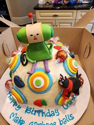 they put a scarf on a cat, this a katamari damacy themed cake and they nailed it.