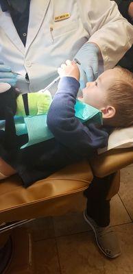 My toddler getting his teeth cleaned a learning about the fun dentist tools