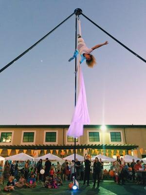 An outdoor aerial performance by Lucy