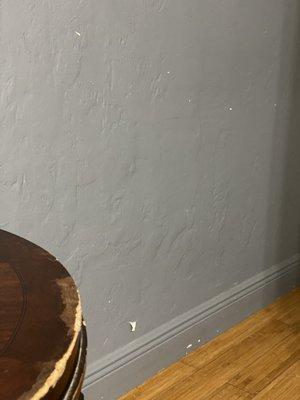 Beat up nightstand and peeling on walls found everywhere throughout the unit