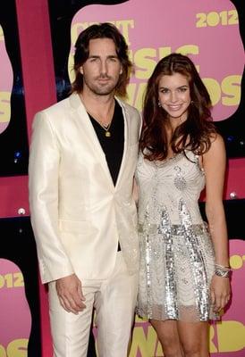 Jake Owen & wife Lacey. Jake is wearing a Dolce & Gabbana suit from Traffic Men and Lacey is in Balmain from Traffic Women.