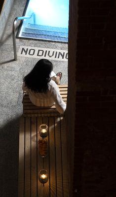 Spa guest seated beside the cold plunge pool