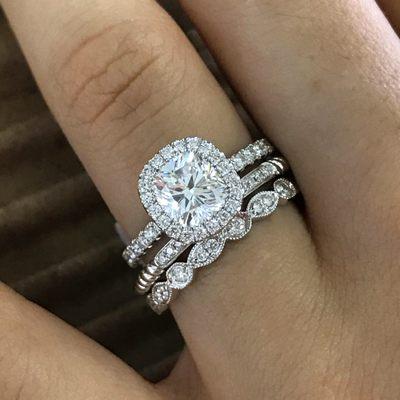 Cushion Brilliant cut diamond set into a Halo-Style Engagement Ring with 2 stackable bands