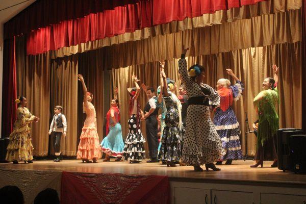 Dancers performing to music on the raised stage