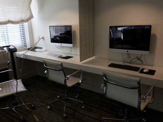 Business area with four computers & a printer.