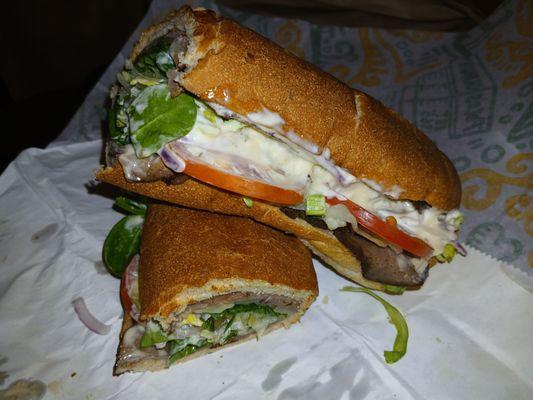 Garlic roast beef and provolone on whole wheat foot long hero bread.