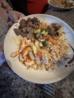 Steak and shrimp with fried rice and vegetables