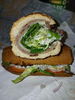 Garlic roast beef and provolone on whole wheat foot long hero bread.