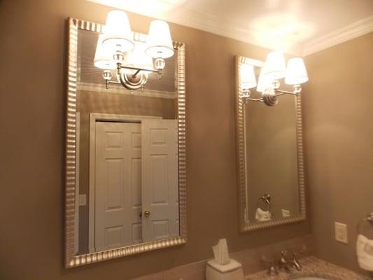 Mirrors made to go over a double sink with holes for the light fixture.