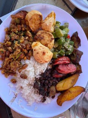 Cheese puffs, Okra salad, Pinto Beans with Yucca Side, White Rice, Black Beans, Sausage and unknown steak recommended by staff