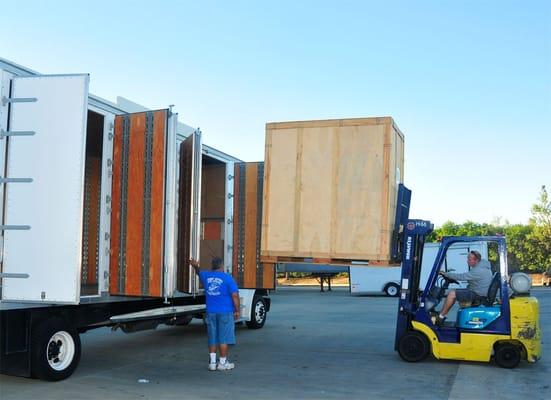 The storage vaults can either be loaded onto a flatbed or into our 26' box trucks for full service storage pickup and delivery.