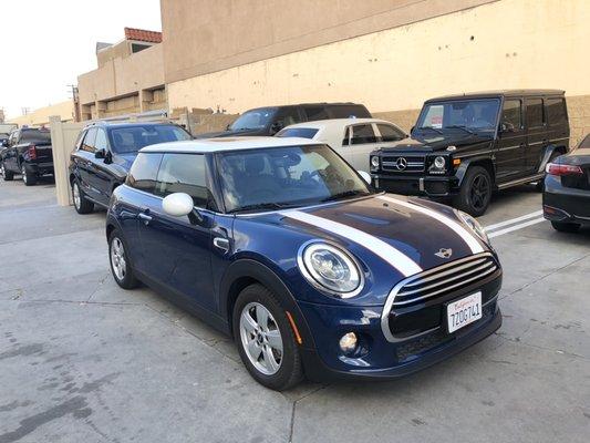 Vinyl wrap Gloss white racing stripes with orange pin stripes installed on the hood and rear tailgate