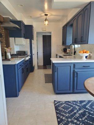 After-cabinet removal, hood installation, new countertops and tile backsplash.