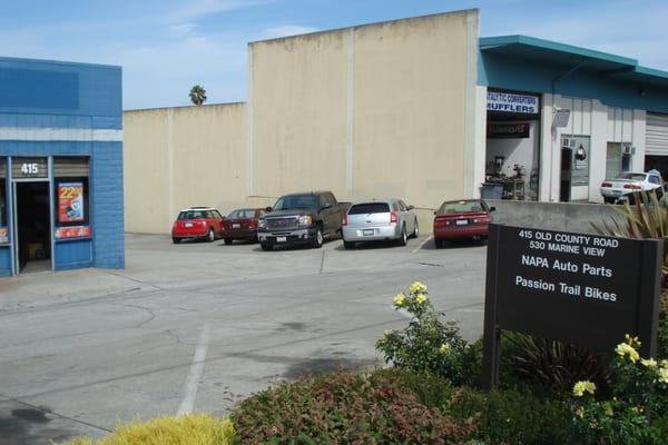 Entrance to the driveway to Express Towing car lot on the right side of the Napa Auto Parts building.