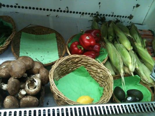 fresh mushrooms, red bell peppers, lemon, avocado, corn, carrots (taken 20 mins before closing, hence the empty baskets)