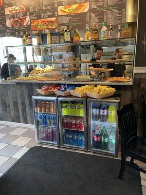 The pizza counter with a vast selection of different slices!