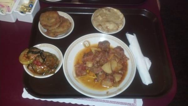 Clockwise from left: zucchini and tomatoes, fried green tomatoes, banana pudding, and the beef stew entree