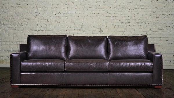 The track armed Durham leather sofa with nail trim.