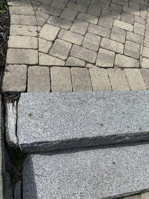 No proper drainage, water destroying the front stairs and pavers.