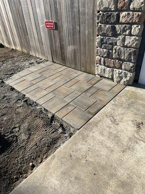 New paver walkway leading to the gate. The dirt will be turned into a planting bed with drip irrigation.