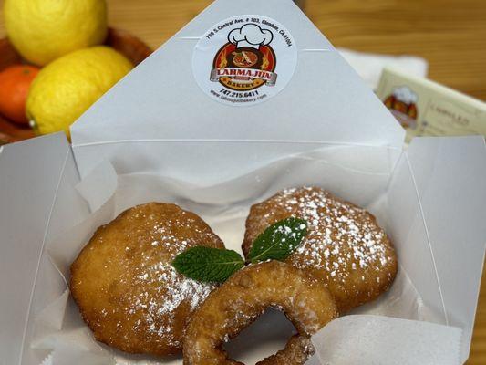 Custard filled ponchiks (beignet) and beignet-style doughnuts.